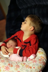 Ashley's son holding baby sis