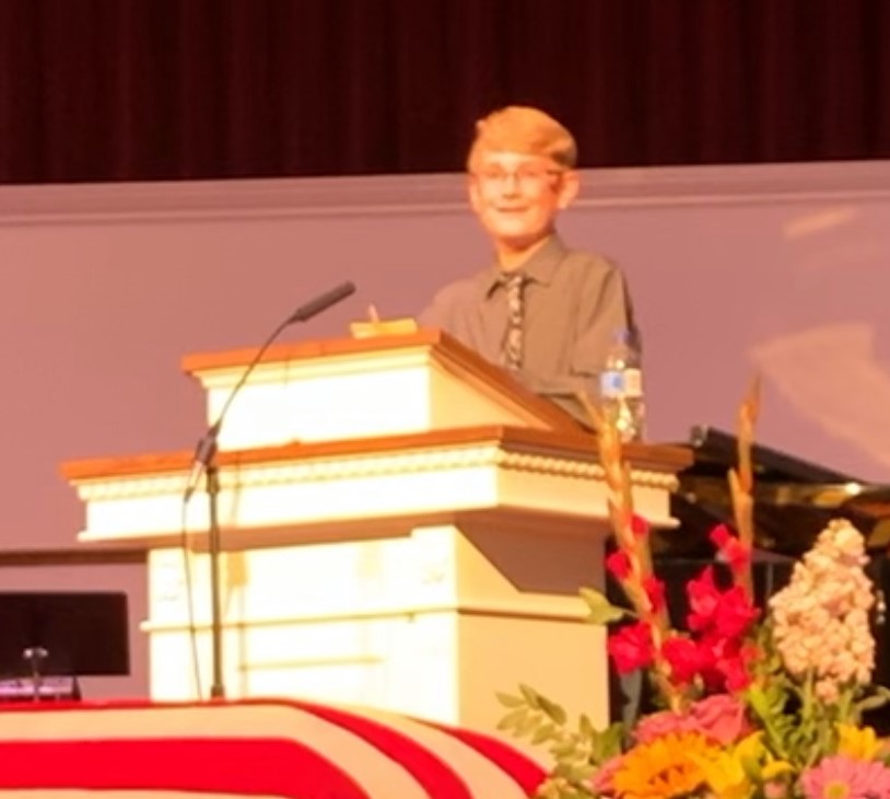 Will Doyle giving the eulogy at the funeral of his grandfather, Jerry Reed.